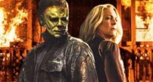 Michael Myers (James Jude Courtney) and Laurie Strode (Jamie Lee Curtis) in 'Halloween Ends' with the burning house from 'Halloween Kills' behind them